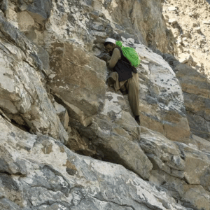 A man is climbing for Shilajit